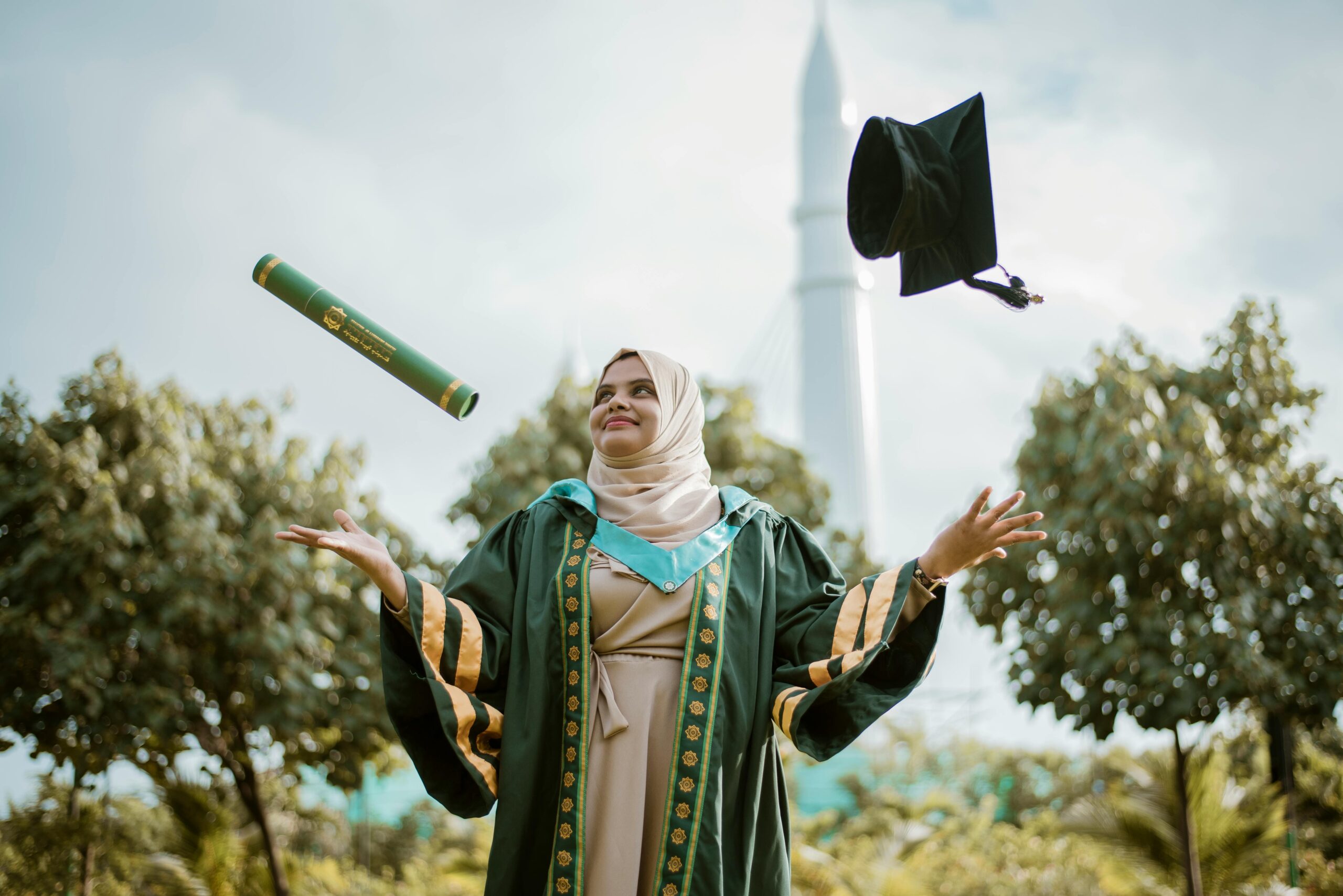 Portrait of a Muslim woman celebrating graduation outdoors in a park, Maldives.
